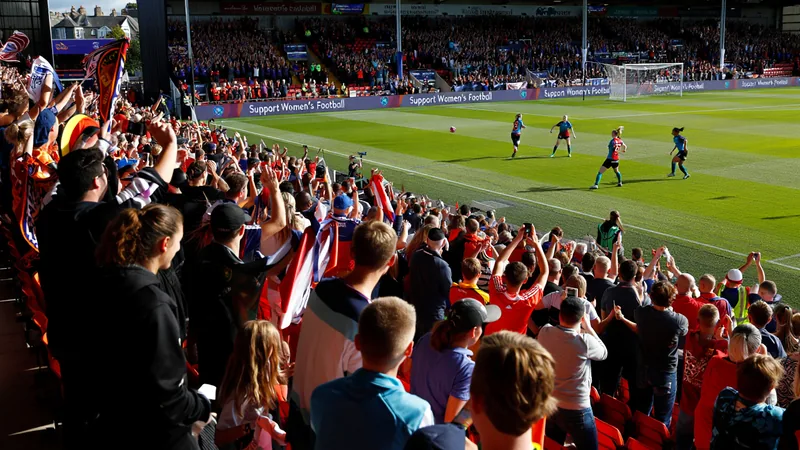WSL fan experience: What works and what needs improvement Fans cheering at a women's football match in a stadium with banners and flags, showing a lively atmosphere. — latest news and analysis.