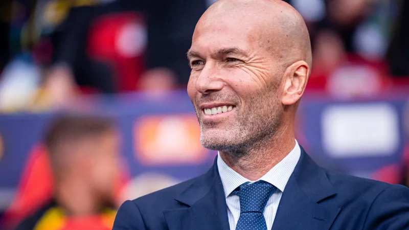 Zinedine Zidane coaching from the sidelines, with the French national team logo in the background. — latest news and analysis.