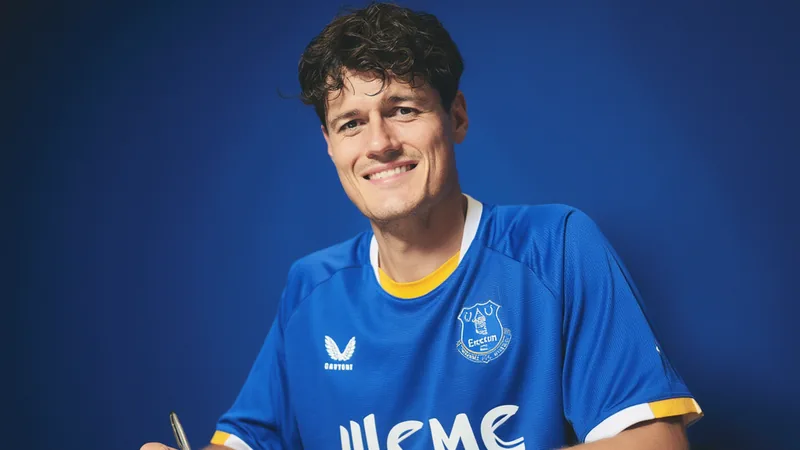 Christian Nørgaard in Everton kit signing contract at the club's training ground.