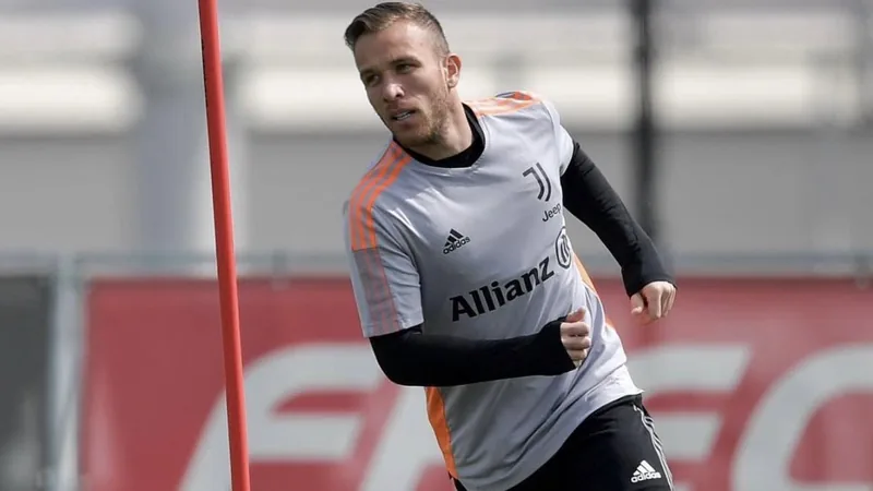 Juventus Offer Arthur Melo Contract Termination Arthur Melo in Juventus kit during a match, with the club's stadium in the background.