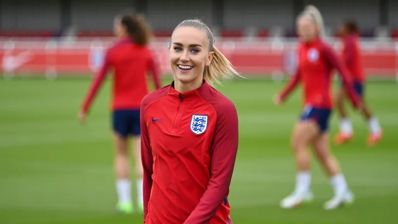Erica Meg Parkinson in England training kit, smiling during a football session.