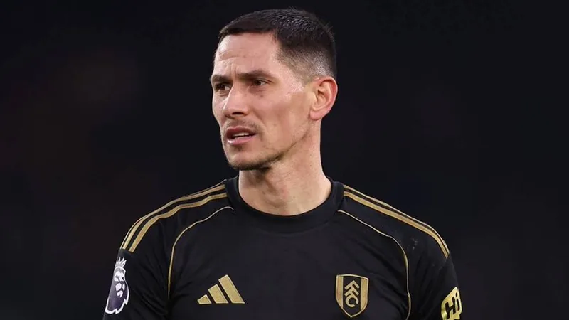 Sasa Lukic Passes Ipswich Medical Ahead of £9m Move Sasa Lukic in Fulham kit during a match, with a football field in the background.
