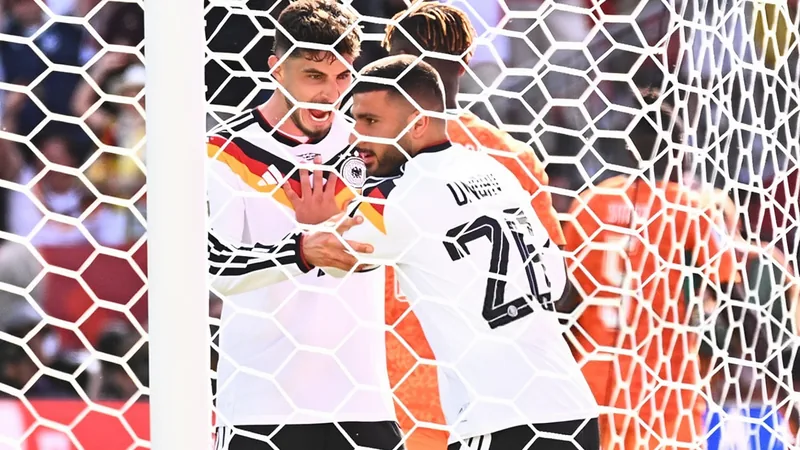 Kai Havertz im Deutschland-Trikot jubelt nach einem Tor, im Hintergrund das Stadionpublikum und die DFB-Bank — latest news and analysis.
