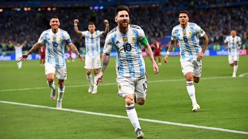 WM-Rekorde, die 2026 fallen könnten — Football World Cup News Lionel Messi im argentinischen Trikot jubelt nach einem Tor im WM-Spiel gegen Algerien, im Hintergrund die Stadionkulisse.