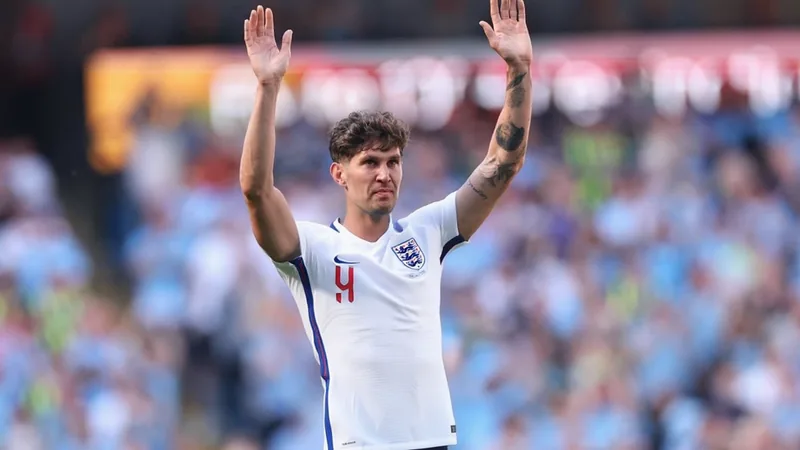 John Stones im Trikot von Manchester City beim Kopfball in einem Premier-League-Spiel im Etihad Stadium — latest news and analysis.