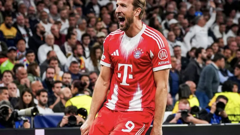 Harry Kane im Trikot des FC Bayern München, den Ball am Fuß, im Stadion bei Flutlicht, konzentriert und bereit zum Schuss.