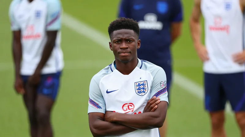 Bukayo Saka in England training kit, looking relaxed during a break