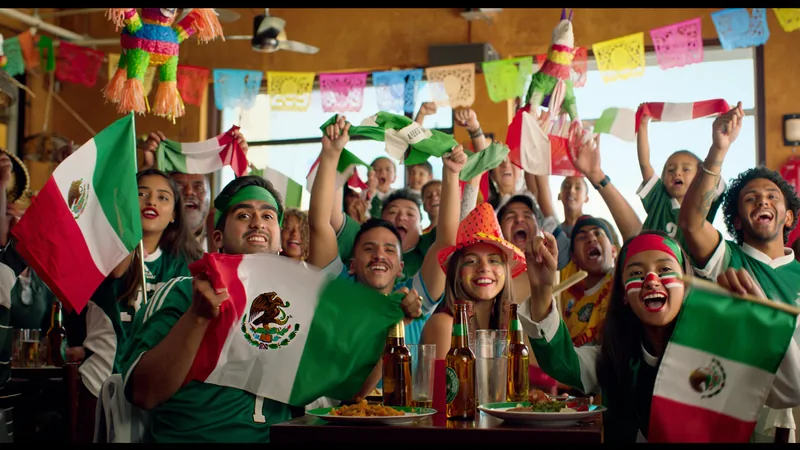 Tras un año de redadas migratorias, el sur de California celebra el Aficionados mexicoamericanos ondeando banderas de México en un bistro abarrotado de Santa Ana, California, durante un partido del Mundial.