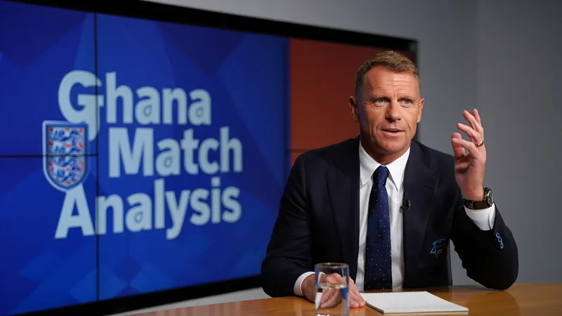 Angleterre vs Ghana : Shearer confiant grâce au banc — Football World Alan Shearer en costume-cravate souriant devant un micro lors d'une émission télévisée sportive — latest news and analysis.