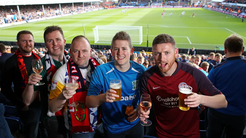 Vente d'alcool autorisée en WSL — Football World Cup News Supporters dans un stade de football féminin avec des gobelets de bière, célébrant un but sur le terrain. — latest news and analysis.