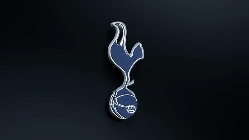 Un joueur de football en tenue de Tottenham Hotspur sur un terrain vert, avec le logo du club en arrière-plan — latest news and analysis.