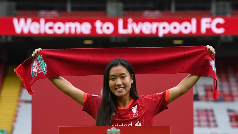 Liverpool recrute Mao Itamura de Feyenoord — Football World Cup News Mao Itamura en tenue de Liverpool posant avec le maillot numéro 26 devant le stade d'Anfield — latest news and analysis.