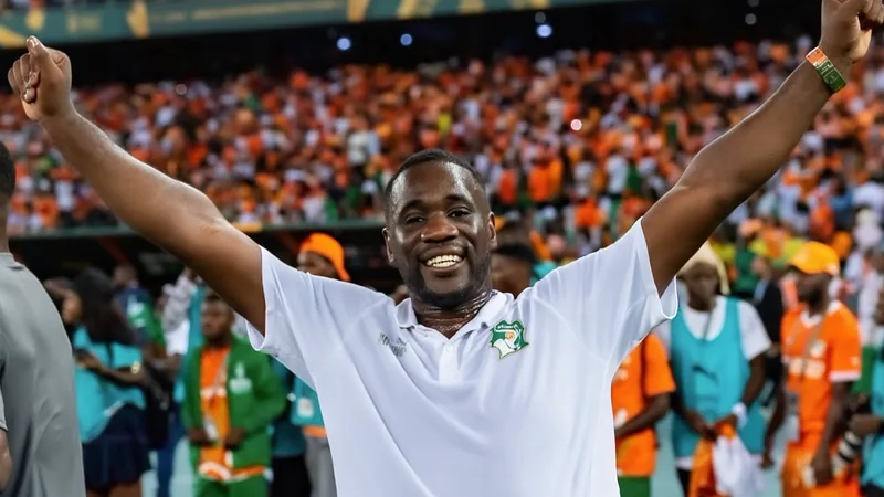 Emerse Faé quitte la Côte d'Ivoire — Football World Cup News Emerse Faé, entraîneur de la Côte d'Ivoire, quittant le terrain avec un regard déterminé, entouré de joueurs ivoiriens en tenue orange.