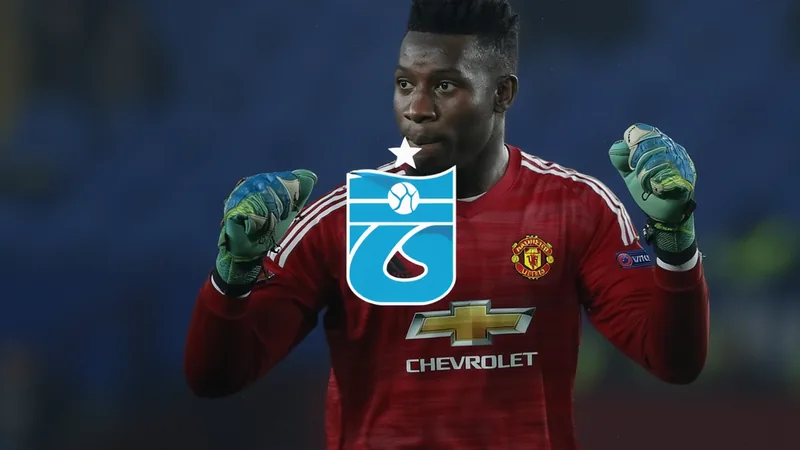 André Onana, guarda-redes camaronês, com o equipamento do Manchester United, em campo durante um jogo de futebol, com expressão concentrada.