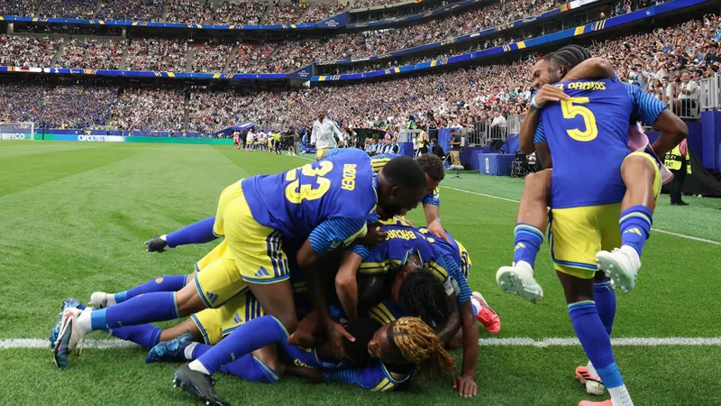 Primeiros golos de seleções no Mundial 2026 — Football World Cup News Jogadores de futebol de diferentes seleções a comemorar golos em campo, com bandeiras nacionais ao fundo e estádio lotado.
