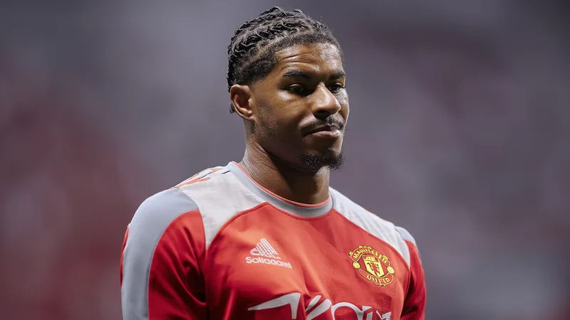 Marcus Rashford em campo com a camisa do Manchester United, durante uma partida noturna, com a torcida ao fundo. — latest news and analysis.