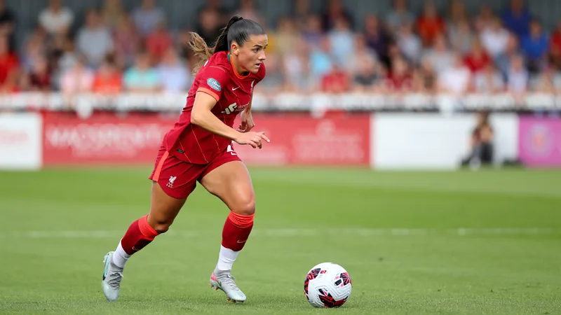 Jogadora de futebol Leanne Kiernan com a camisa do Liverpool em campo, comemorando um gol, com torcida ao fundo. — latest news and analysis.